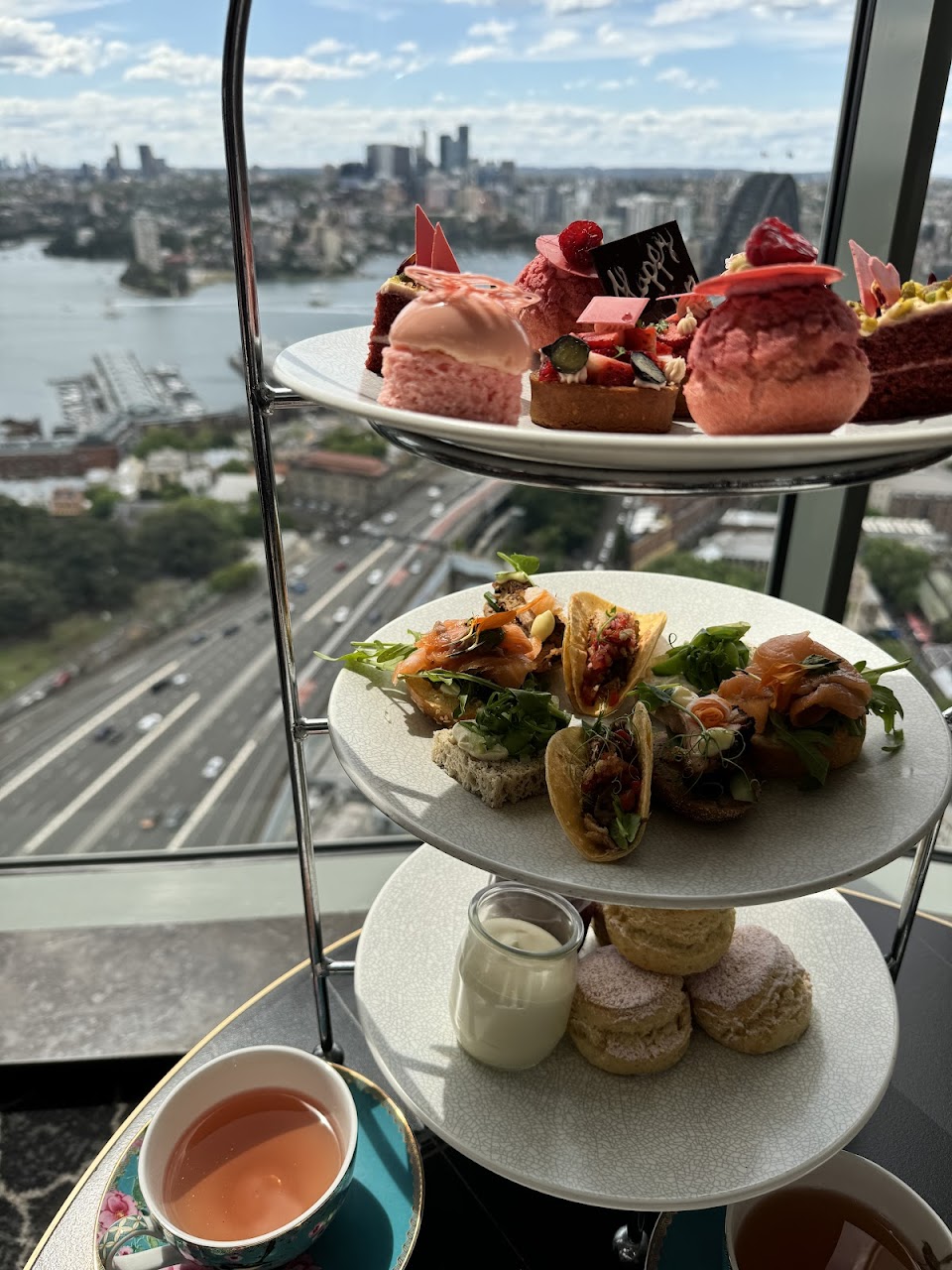 High tea tier by the windows overlooking Sydney Harbour